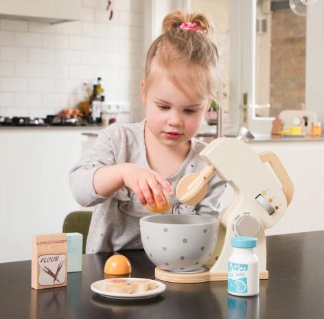 Children playing with play food and kitchen accessories